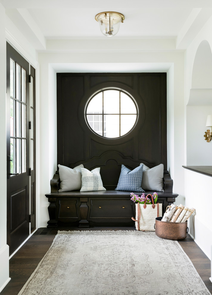 Design ideas for a traditional foyer in Minneapolis with white walls, dark hardwood floors, a single front door and a glass front door.