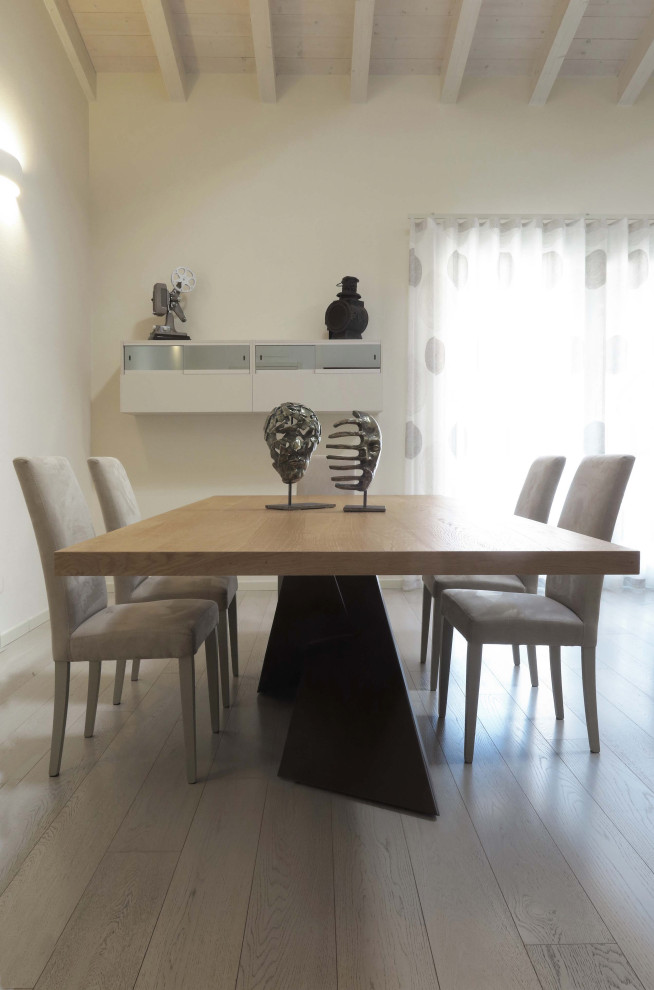 This is an example of a contemporary dining room in Other with white walls, light hardwood floors and white floor.