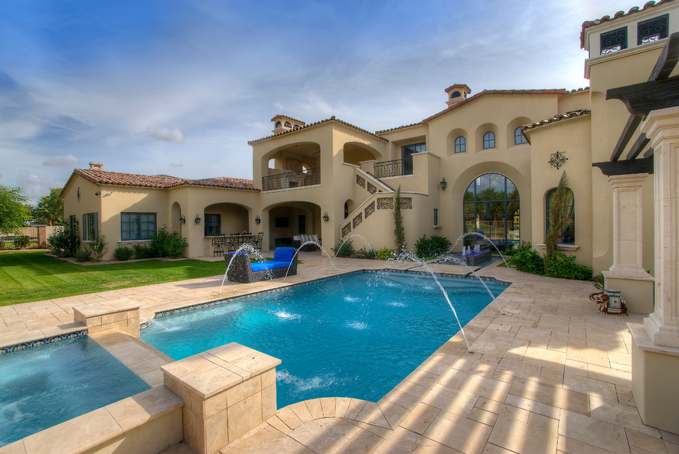 Huge transitional backyard concrete paver and rectangular lap pool fountain photo in Phoenix