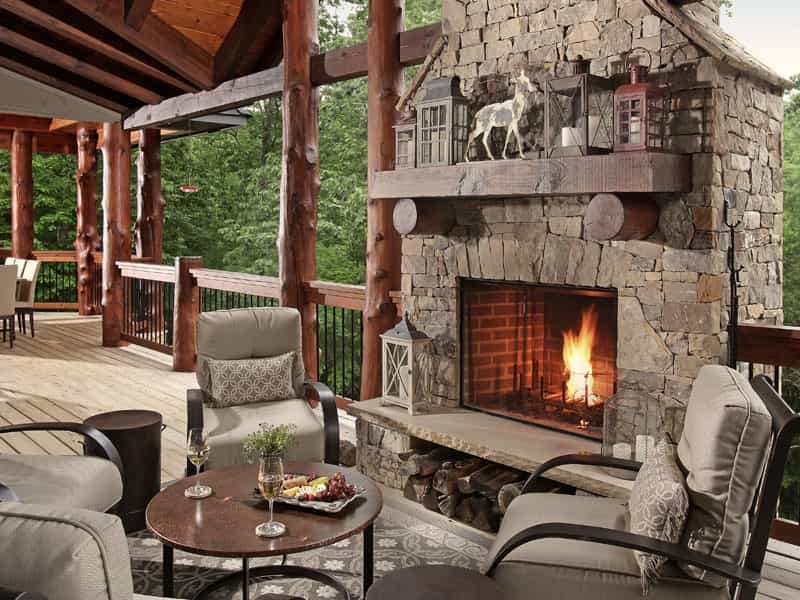 Deck - large rustic backyard deck idea with a fire pit and a roof extension