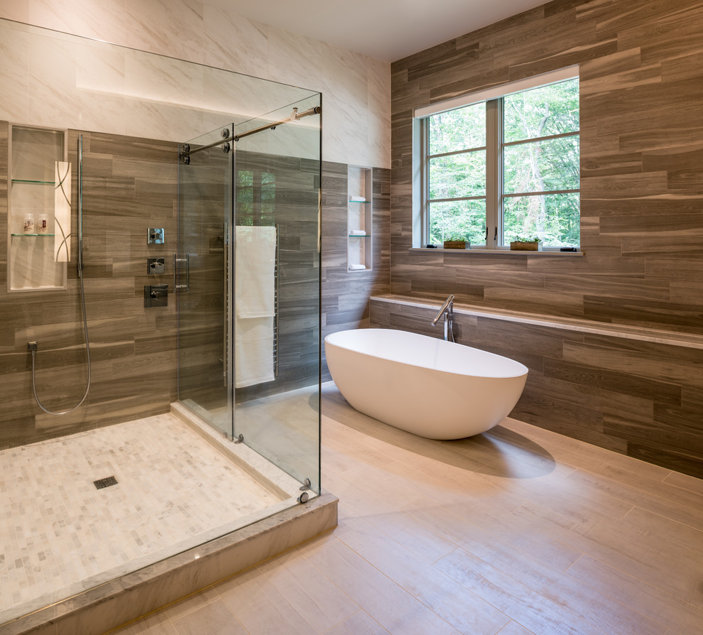 Design ideas for a large transitional master bathroom in Philadelphia with flat-panel cabinets, grey cabinets, a freestanding tub, a corner shower, a bidet, gray tile, grey walls, a vessel sink, grey floor and a sliding shower screen.