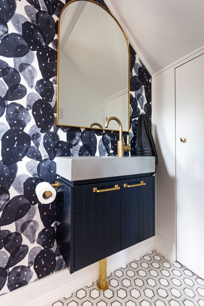 Inspiration for a contemporary powder room in Sydney with raised-panel cabinets, blue cabinets, white walls, an integrated sink, multi-coloured floor, grey benchtops, a built-in vanity, vaulted and wallpaper.