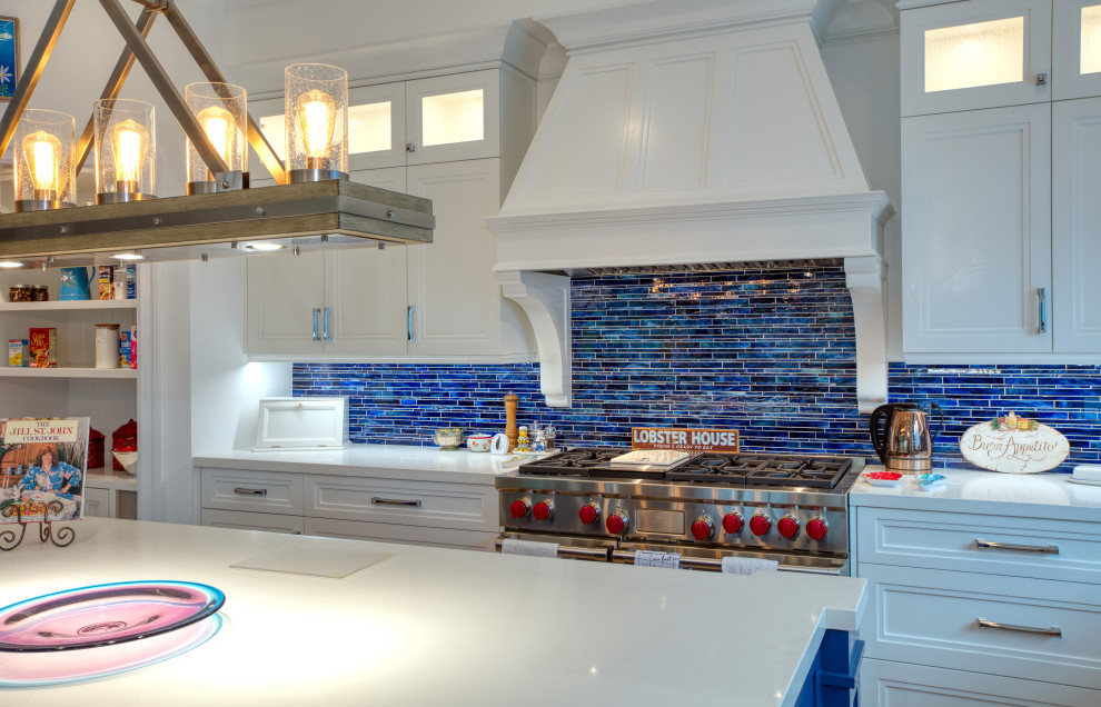 This is an example of a large traditional l-shaped eat-in kitchen in Los Angeles with an undermount sink, recessed-panel cabinets, white cabinets, marble benchtops, blue splashback, matchstick tile splashback, stainless steel appliances, with island and white benchtop.