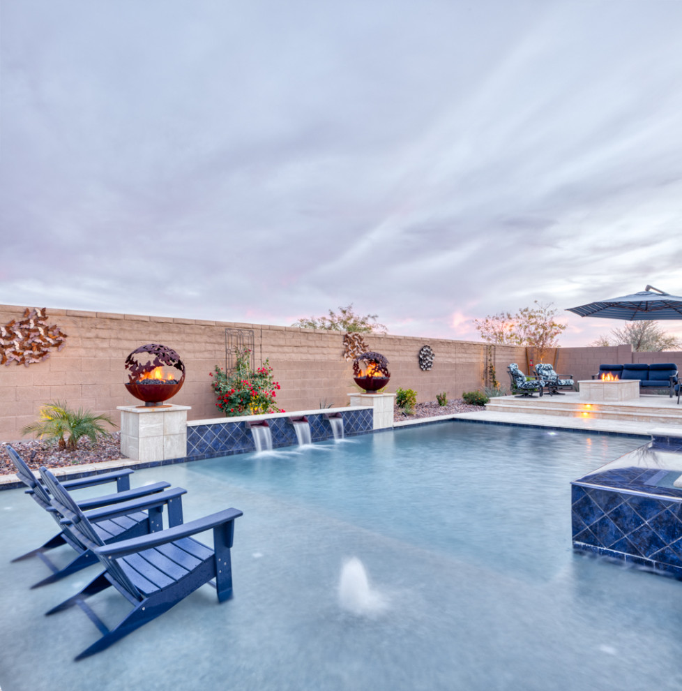 Large contemporary backyard rectangular natural pool in Phoenix with with a pool and concrete pavers.