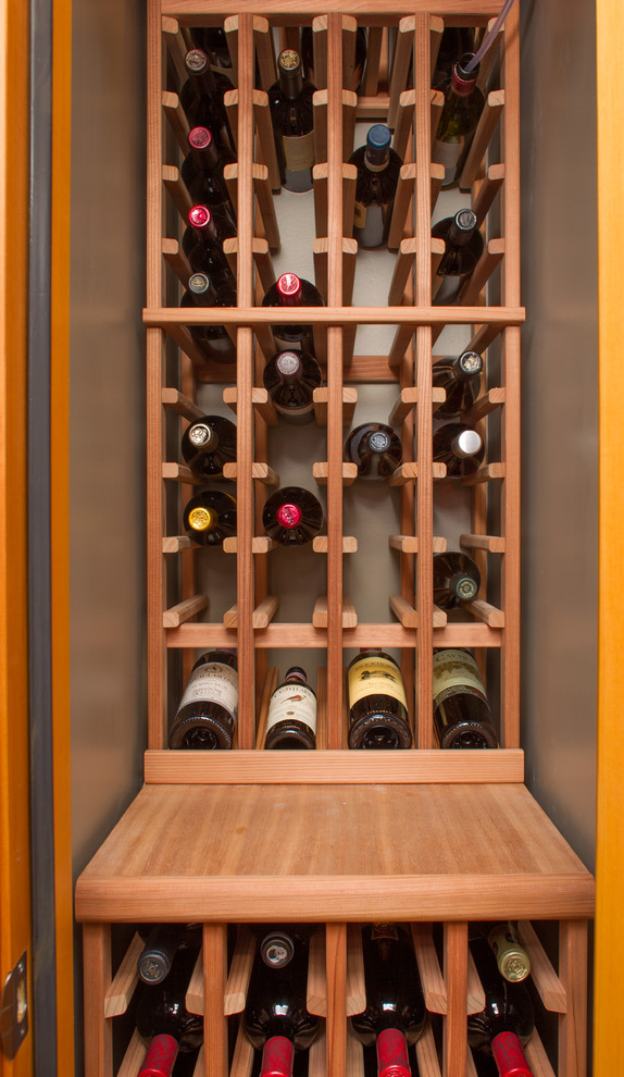 Photo of a small traditional wine cellar in Vancouver with storage racks.