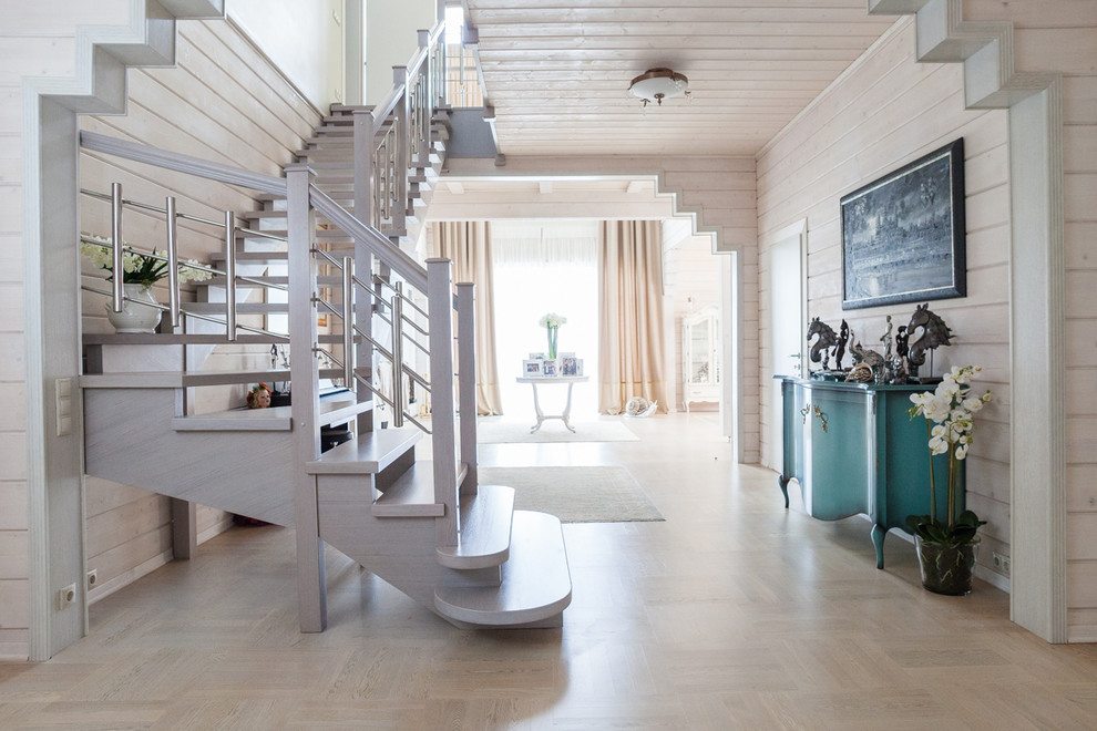 This is an example of a scandinavian wood curved staircase in Moscow with open risers.