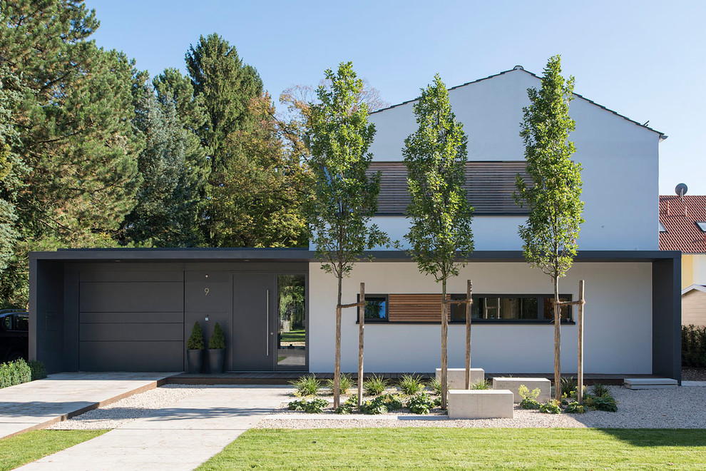 Large contemporary split-level white exterior in Munich with a gable roof.