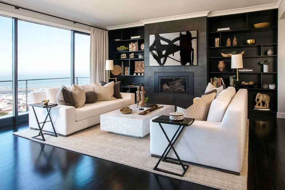This is an example of a large contemporary open concept living room in San Francisco with grey walls, dark hardwood floors, a standard fireplace, a tile fireplace surround and black floor.