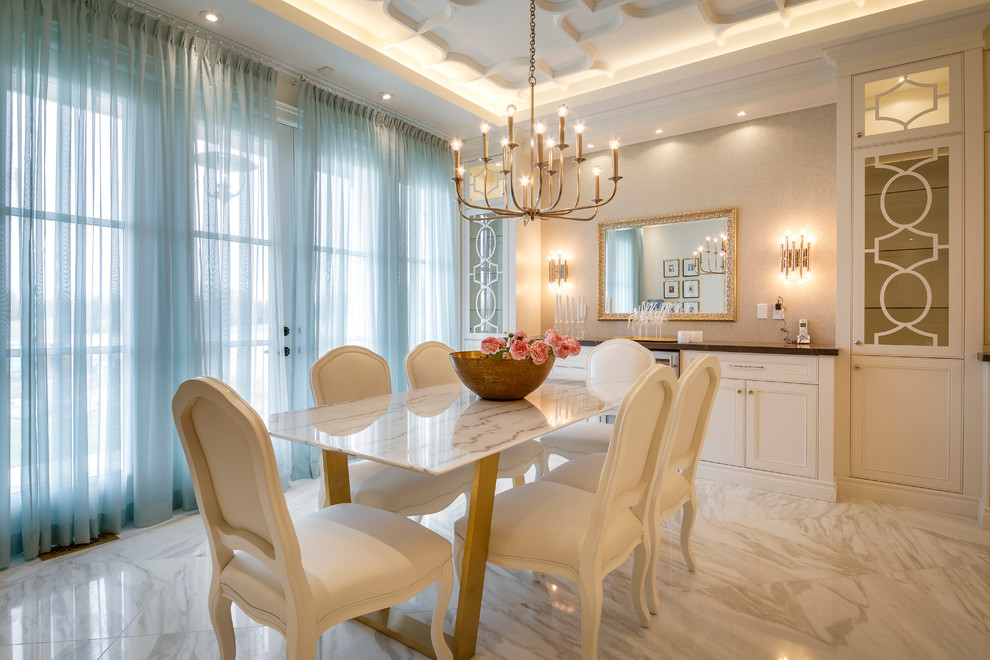 Photo of a large transitional separate dining room in Toronto with marble floors.