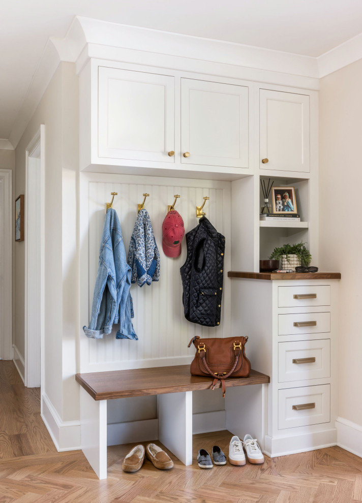 Inspiration for a transitional medium tone wood floor and brown floor mudroom remodel in DC Metro with beige walls