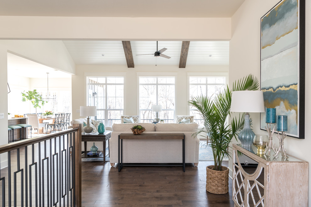 Inspiration for a mid-sized beach style foyer with white walls, medium hardwood floors, a single front door, a medium wood front door and brown floor.