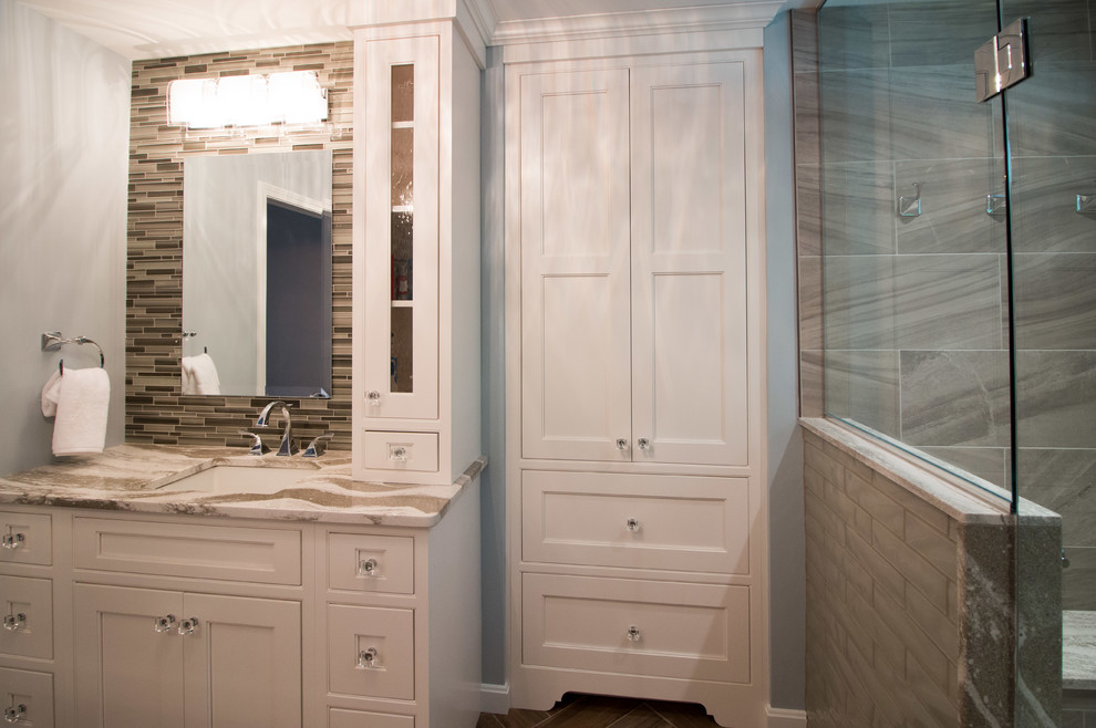 This is an example of a mid-sized modern master bathroom in Boston with beaded inset cabinets, white cabinets, an alcove shower, a two-piece toilet, multi-coloured tile, porcelain tile, blue walls, porcelain floors, an undermount sink, engineered quartz benchtops, brown floor, brown benchtops and a hinged shower door.