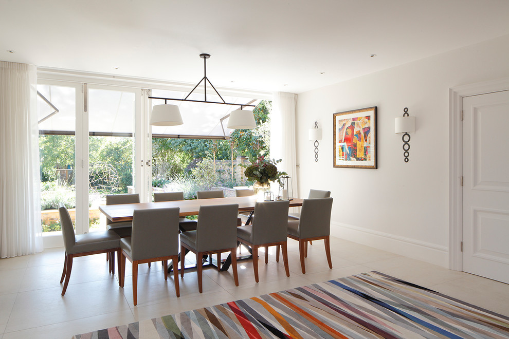 Inspiration for a contemporary dining room in London with white walls and beige floor.