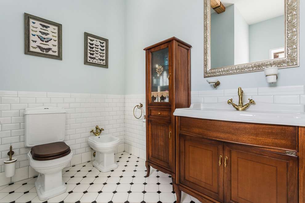 Photo of a mid-sized traditional master bathroom in Moscow with white tile, blue walls, ceramic floors, recessed-panel cabinets, medium wood cabinets, a bidet, subway tile, an integrated sink, white floor, a freestanding tub, white benchtops, an enclosed toilet, a single vanity, a freestanding vanity and exposed beam.