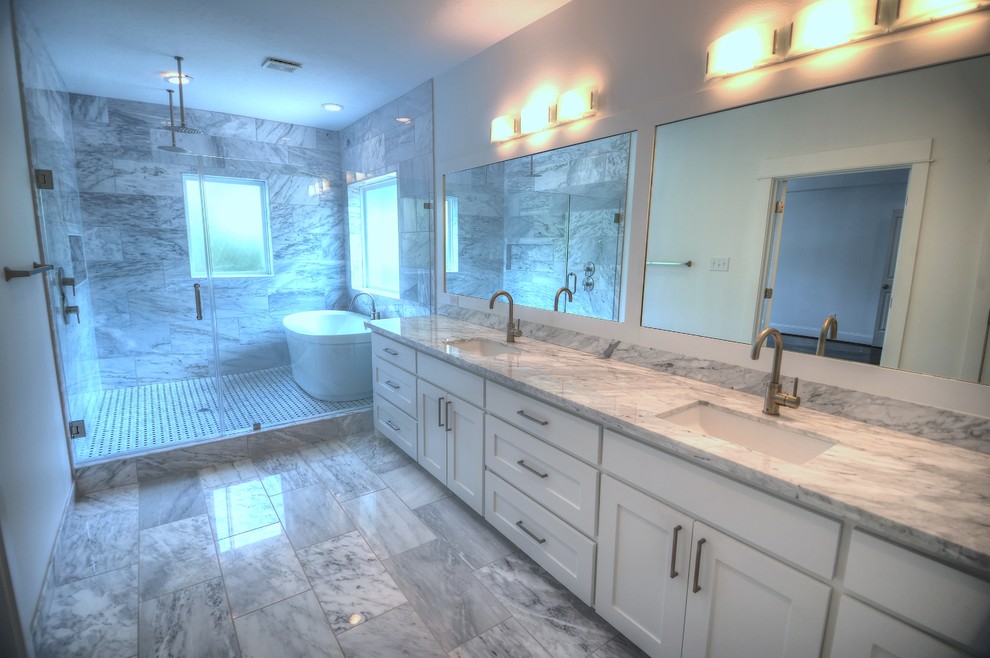 This is an example of a large contemporary master bathroom in Houston with marble benchtops, a freestanding tub, an open shower, white tile and marble floors.