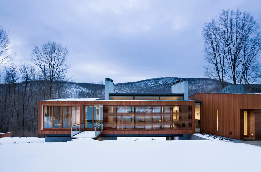 Inspiration for a contemporary one-storey exterior in New York with wood siding.