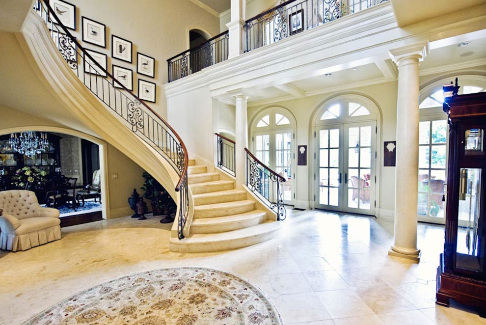Expansive foyer in Dallas with beige walls, porcelain floors and a double front door.