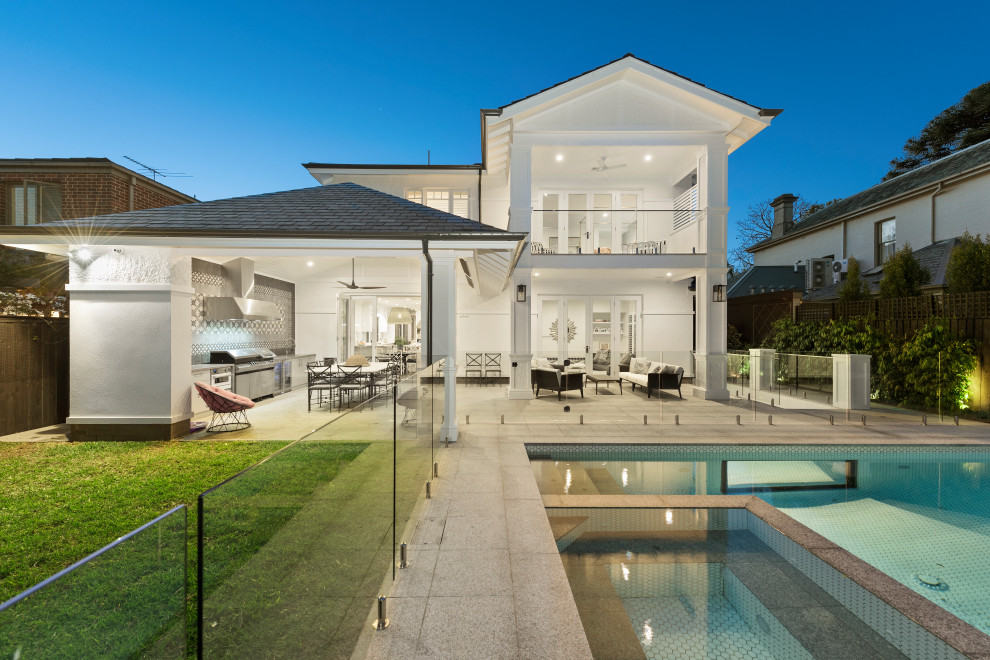 This is an example of a large contemporary backyard rectangular pool in Melbourne with a hot tub and tile.
