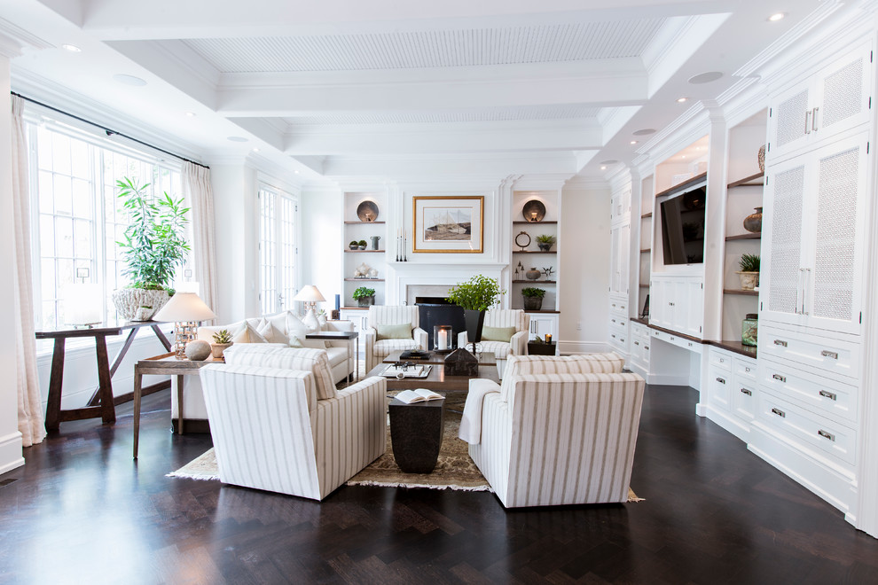 This is an example of a large traditional formal open concept living room in Toronto with dark hardwood floors, a built-in media wall, white walls, a standard fireplace, a tile fireplace surround and brown floor.