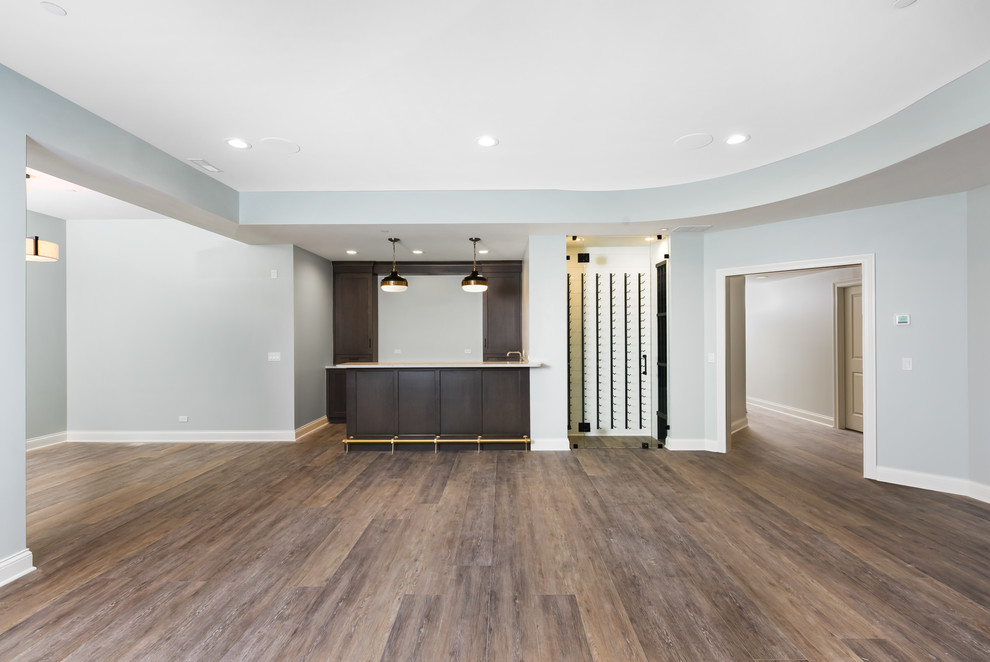 Mid-sized transitional look-out basement in Chicago with grey walls, laminate floors and brown floor.