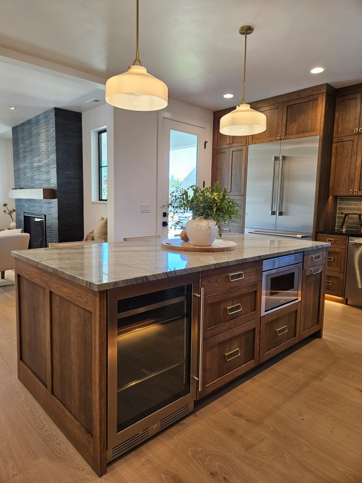 Inspiration for a transitional kitchen remodel with dark wood cabinets and an island