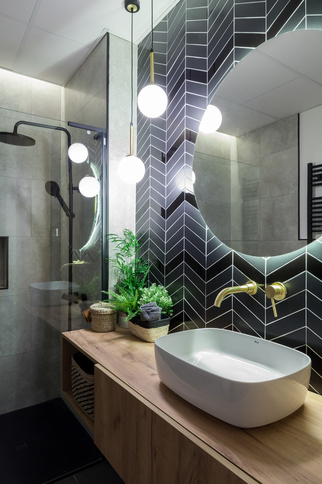 Large scandinavian master bathroom in Madrid with furniture-like cabinets, white cabinets, a curbless shower, a one-piece toilet, black and white tile, ceramic tile, grey walls, ceramic floors, a vessel sink, wood benchtops, black floor, a shower curtain and brown benchtops.