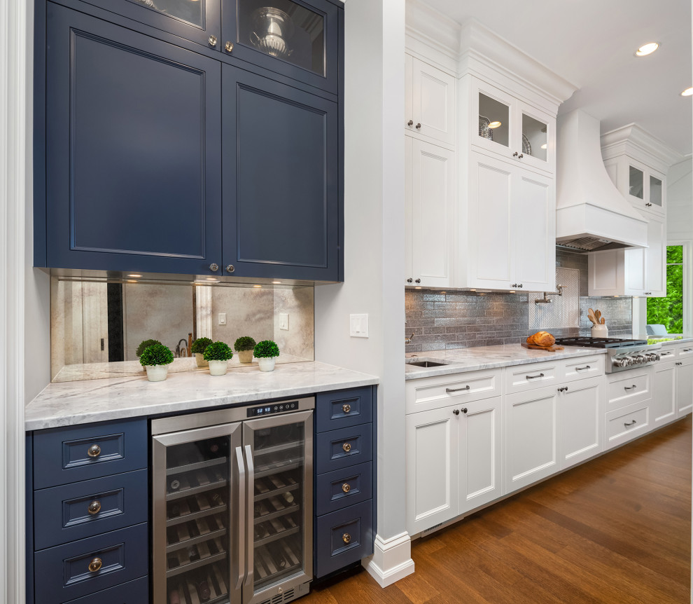 Large beach style home bar in Seattle with an undermount sink, shaker cabinets, white cabinets, marble benchtops, grey splashback, ceramic splashback, medium hardwood floors, brown floor and grey benchtop.