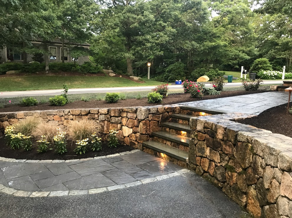 Photo of a contemporary front yard full sun garden in Boston with natural stone pavers.