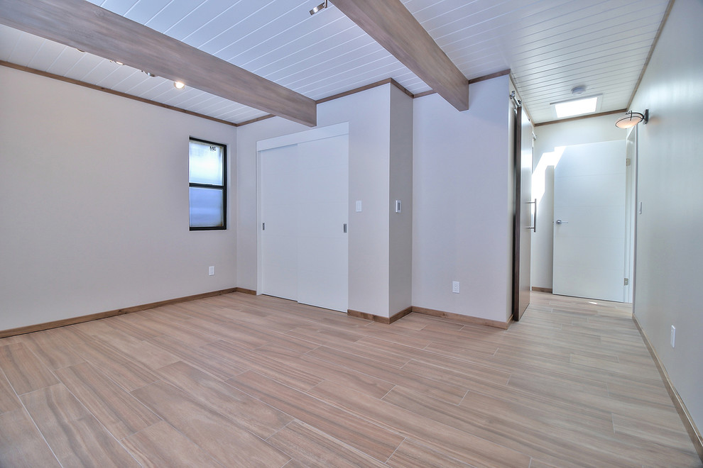 Photo of a midcentury master bedroom in San Francisco with white walls, ceramic floors and multi-coloured floor.