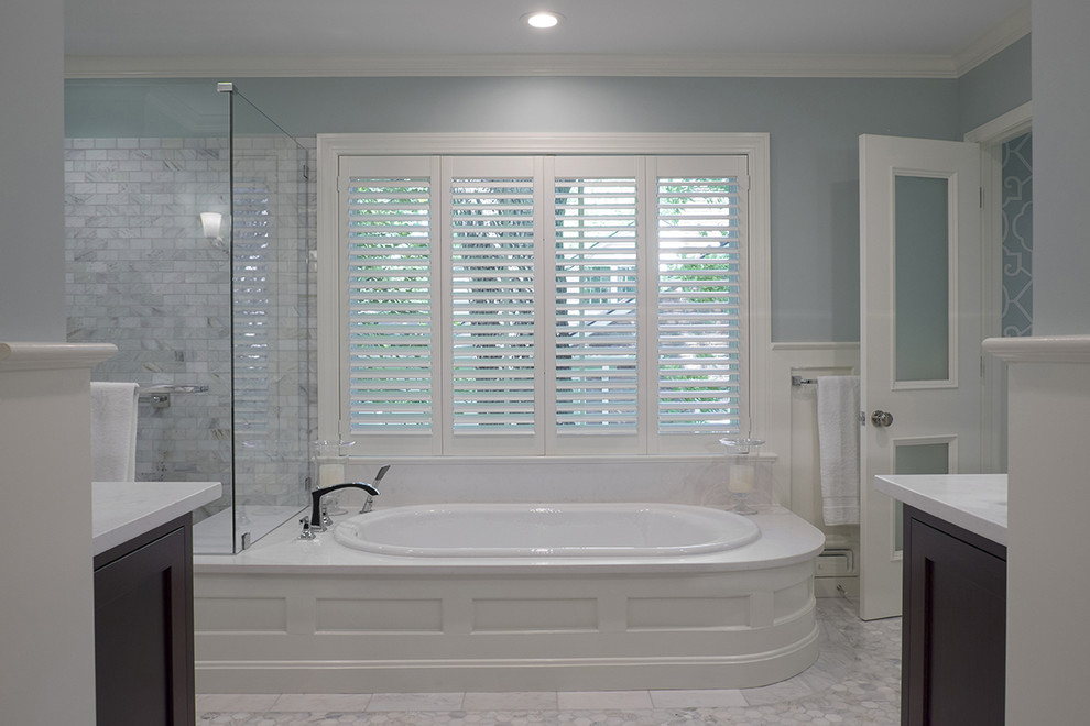 Inspiration for a large traditional master bathroom in Louisville with furniture-like cabinets, dark wood cabinets, a drop-in tub, a corner shower, gray tile, stone tile, blue walls, engineered quartz benchtops and marble floors.