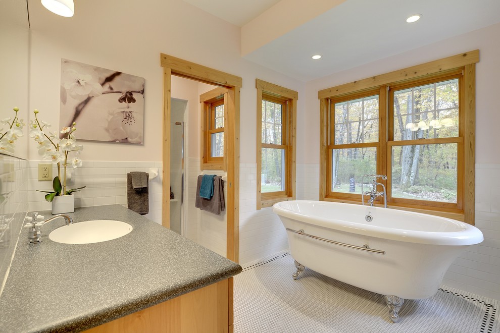 This is an example of a mid-sized country master bathroom in Minneapolis with shaker cabinets, light wood cabinets, a claw-foot tub, a corner shower, a one-piece toilet, black and white tile, mosaic tile, white walls, mosaic tile floors, an undermount sink and soapstone benchtops.