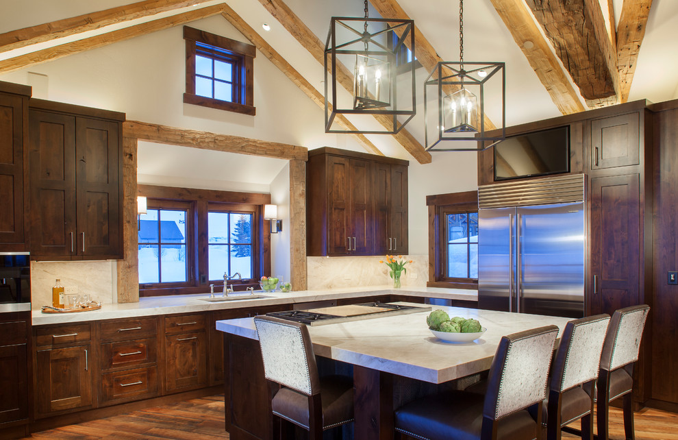 Design ideas for a country l-shaped kitchen in Denver with an undermount sink, shaker cabinets, dark wood cabinets, window splashback, stainless steel appliances, medium hardwood floors, with island and orange floor.