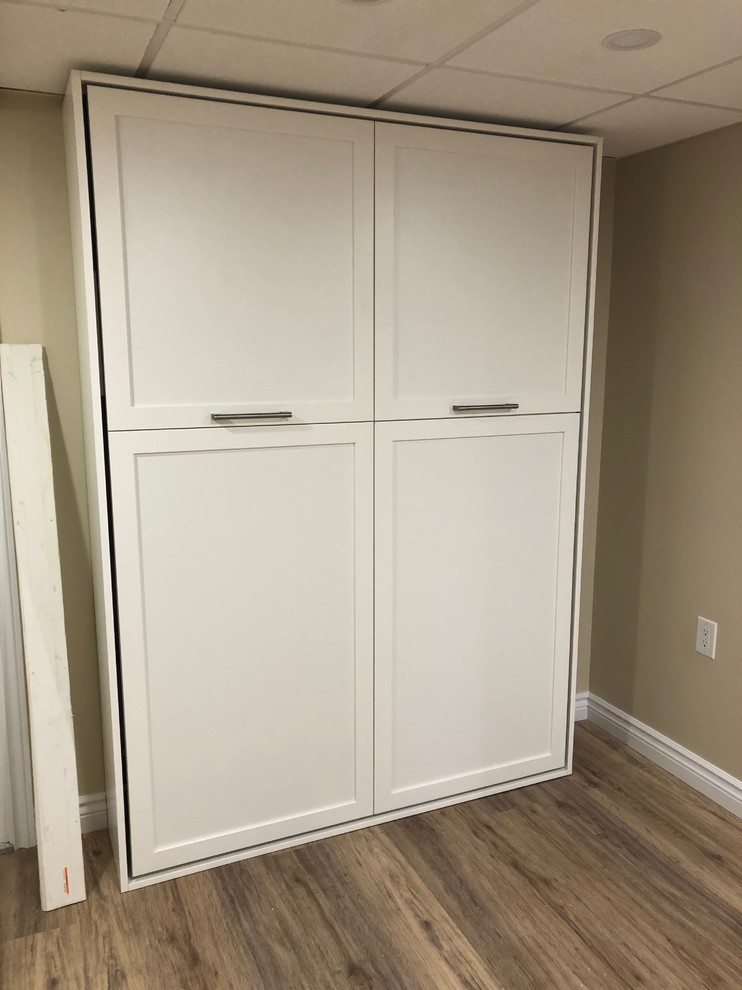 Mid-sized transitional underground vinyl floor and brown floor basement photo with beige walls