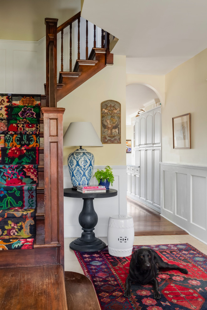 Mid-sized eclectic foyer in Seattle with yellow walls, limestone floors, a single front door, a white front door, yellow floor and decorative wall panelling.