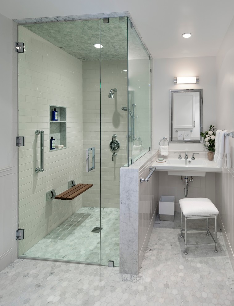 Design ideas for a mid-sized transitional master bathroom in Los Angeles with a wall-mount sink, white tile, subway tile, grey walls, mosaic tile floors, a freestanding tub, a corner shower, grey floor, a hinged shower door, a niche and a shower seat.