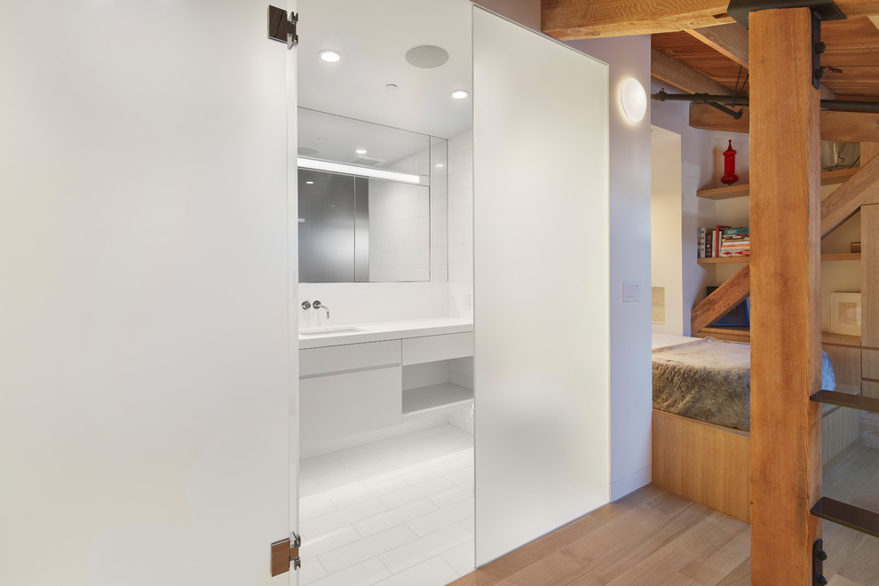 Photo of a contemporary master bathroom in San Francisco with flat-panel cabinets, white cabinets, white tile, an undermount sink, white floor and white benchtops.