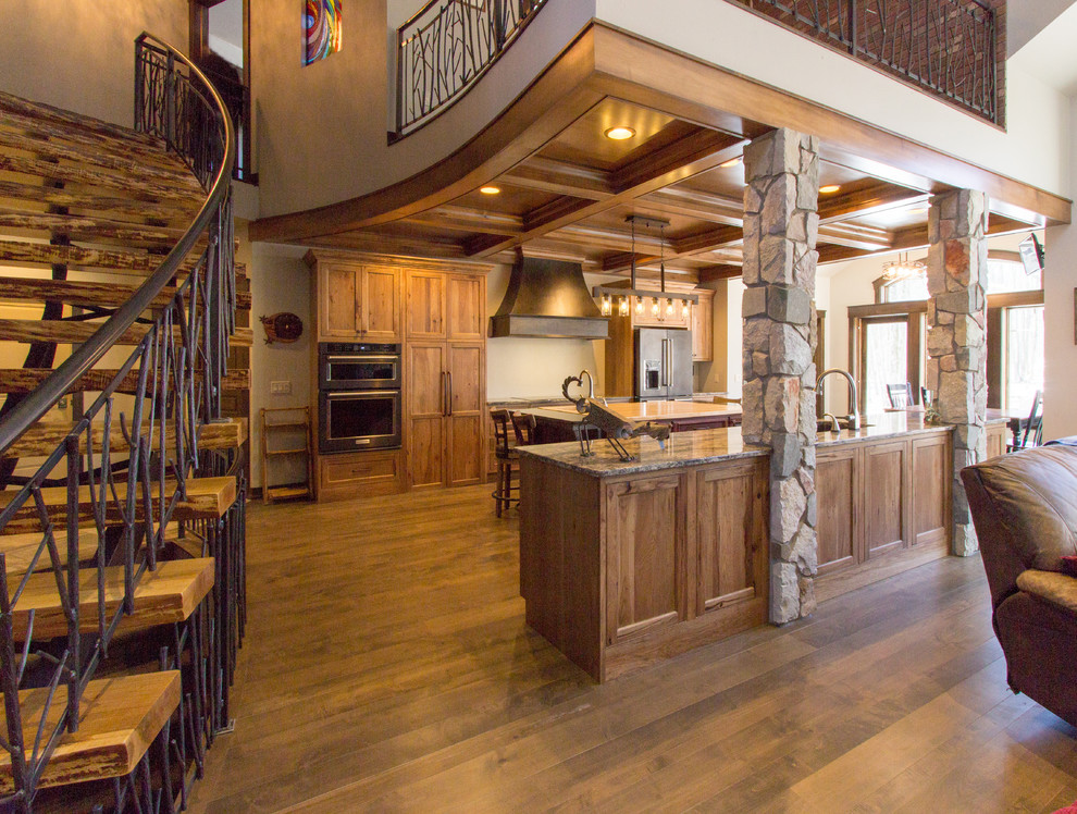 Inspiration for a rustic brown floor kitchen remodel with flat-panel cabinets, medium tone wood cabinets, quartz countertops, stainless steel appliances and two islands