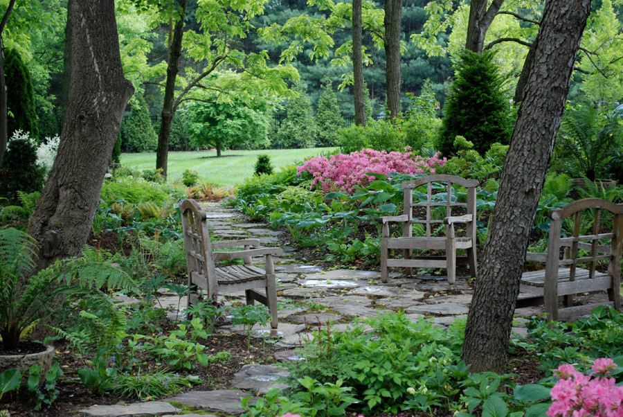 Fieldstone path through the Hosta garden finds small patio w chairs. A great place to relax and read a book!
