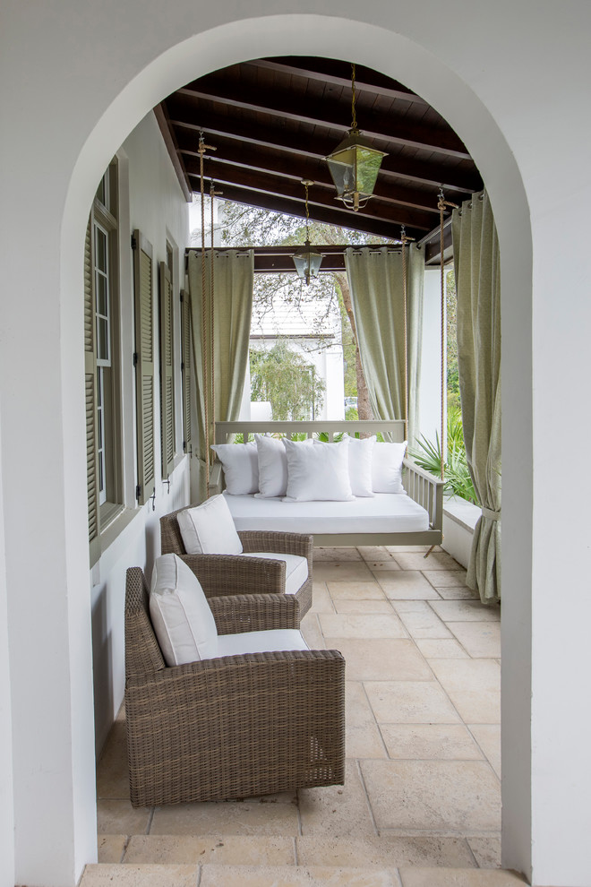 This is an example of a mediterranean verandah in Miami with a roof extension.