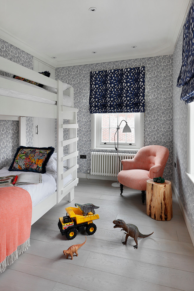 Inspiration for a transitional gender-neutral kids' room in London with multi-coloured walls, grey floor and painted wood floors.