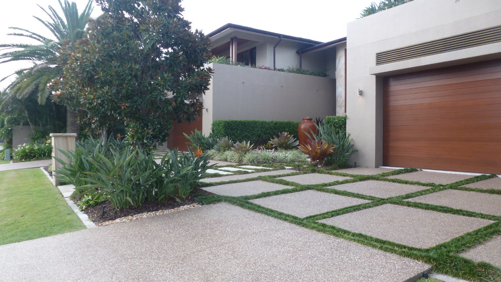 Design ideas for a mid-sized contemporary front yard driveway in Gold Coast - Tweed with a garden path and concrete pavers.
