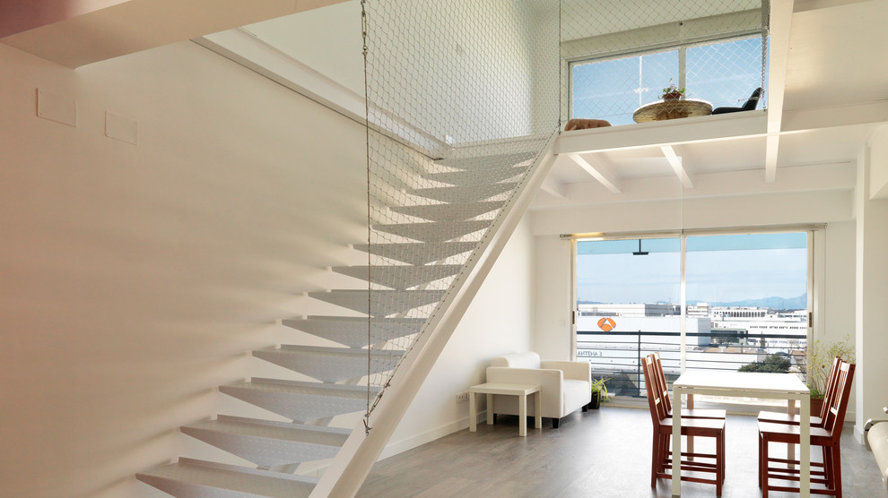 Photo of a mid-sized contemporary metal straight staircase in Madrid with open risers.