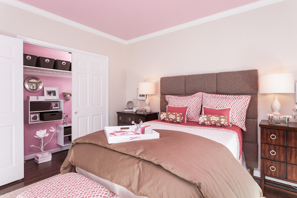 This is an example of a traditional kids' room for girls in Baltimore with pink walls and dark hardwood floors.