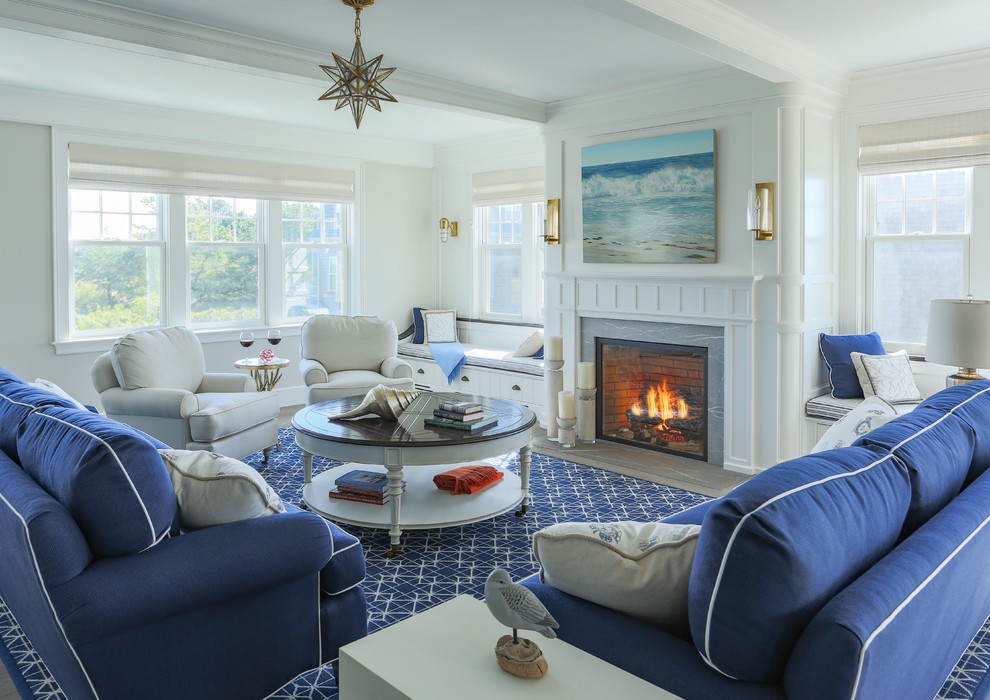 Large beach style open concept living room in Boston with white walls, a standard fireplace, a stone fireplace surround and light hardwood floors.