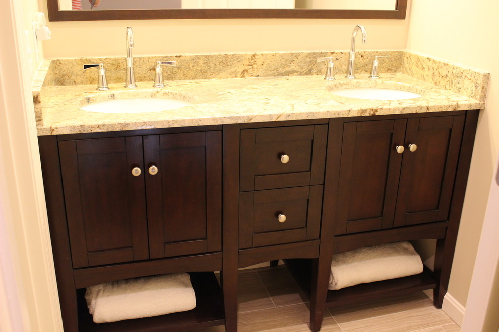 Alcove bathtub - small transitional kids' gray tile and porcelain tile porcelain tile alcove bathtub idea in Cincinnati with furniture-like cabinets, dark wood cabinets, a two-piece toilet, gray walls, an undermount sink and granite countertops