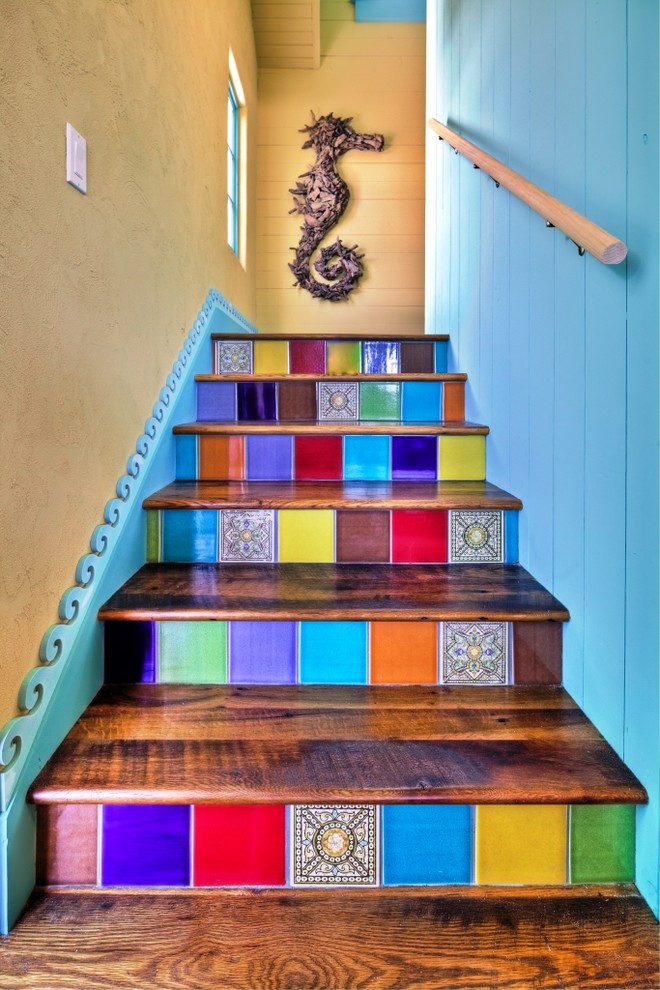 Design ideas for an eclectic wood staircase in Tampa with tile risers.