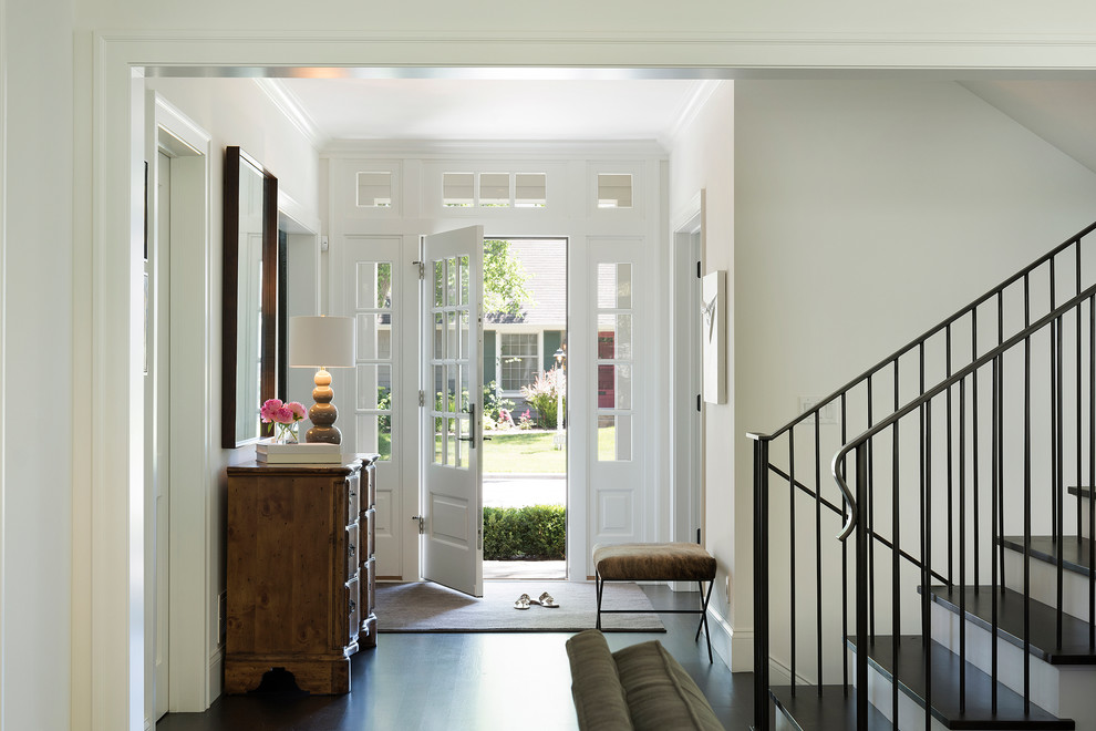 Example of a mid-sized transitional dark wood floor and brown floor hallway design in Minneapolis with white walls