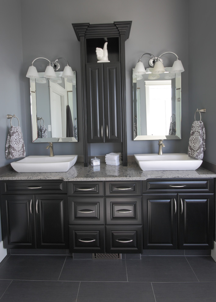 This is an example of a small contemporary master bathroom in Other with a vessel sink, raised-panel cabinets, dark wood cabinets, engineered quartz benchtops, a drop-in tub, a double shower, a one-piece toilet, gray tile, grey walls, terra-cotta floors and grey floor.