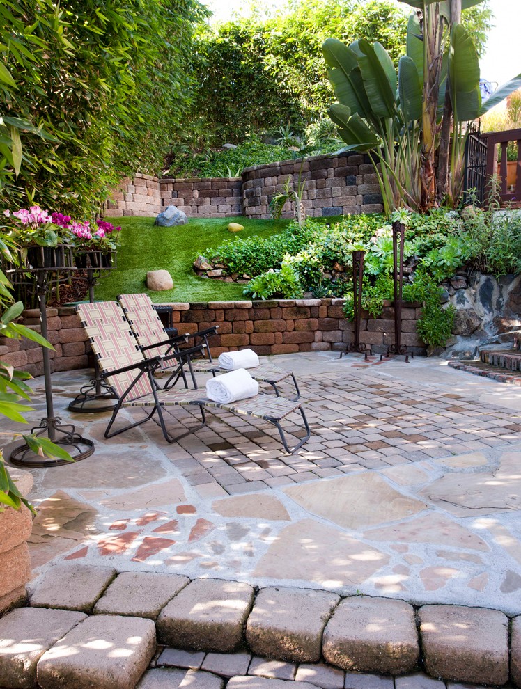 Mediterranean sloped garden in San Diego with brick pavers.