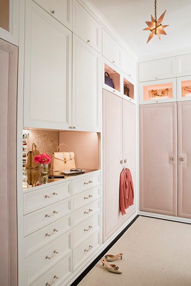 Photo of an expansive traditional women's dressing room in Los Angeles with recessed-panel cabinets, white cabinets, carpet, white floor and coffered.
